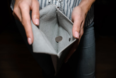 a woman shows a wallet with one coin close up 2025 03 13 05 03 06 utc