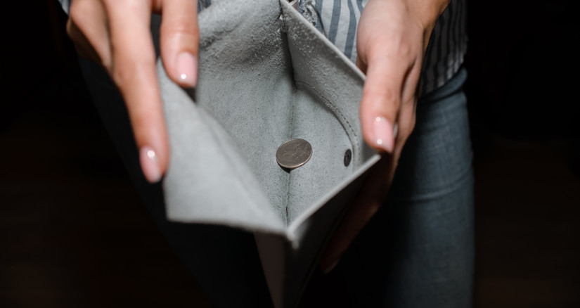 a woman shows a wallet with one coin close up 2025 03 13 05 03 06 utc