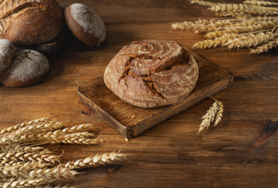 round freshly baked bread on a wooden board in the 2024 09 18 04 15 40 utc