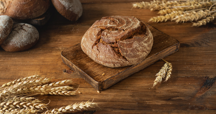 round freshly baked bread on a wooden board in the 2024 09 18 04 15 40 utc